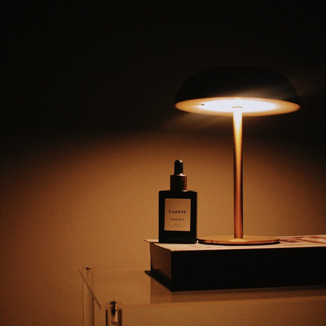 Black perfume bottle with gold cap on a white background