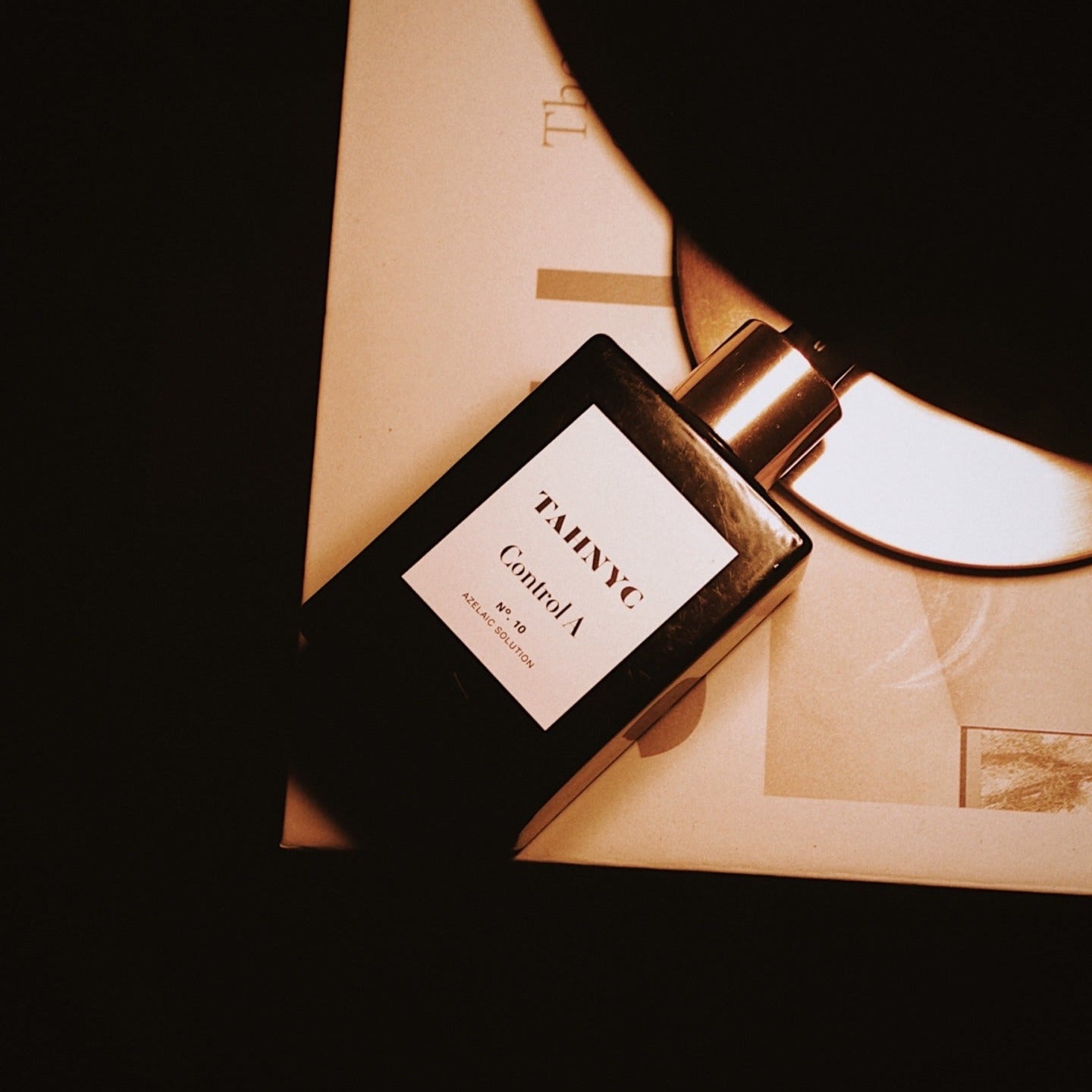 Perfume bottle with 'Tahinye' label on a dark background