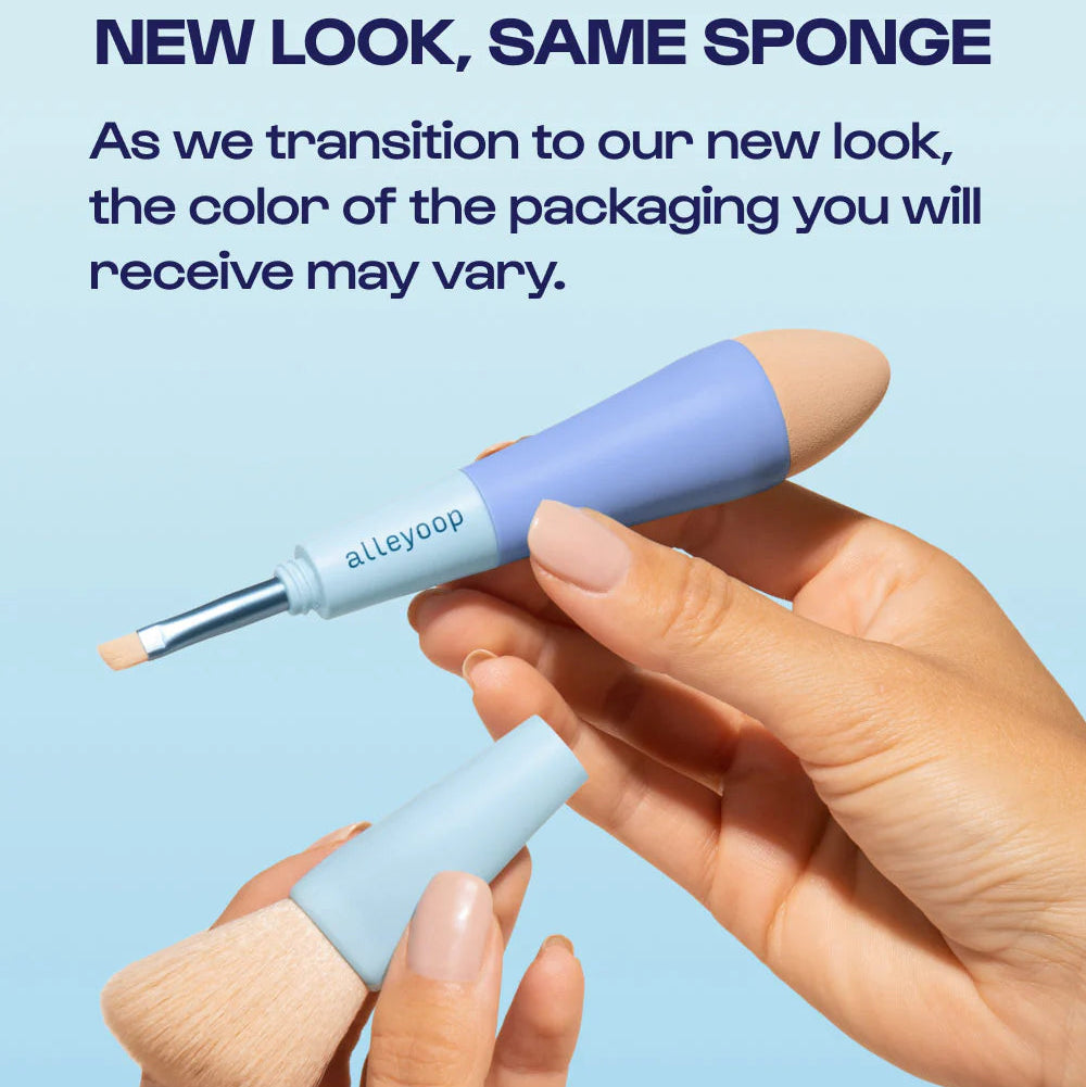 Two makeup brushes with blue handles and beige bristles held by a hand against a light blue background.