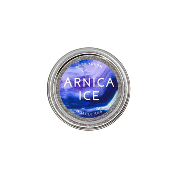 A round metal tin of Into Vukon Arnica Ice Muscle Rub, featuring a blue and purple marbled label on a clean white background.