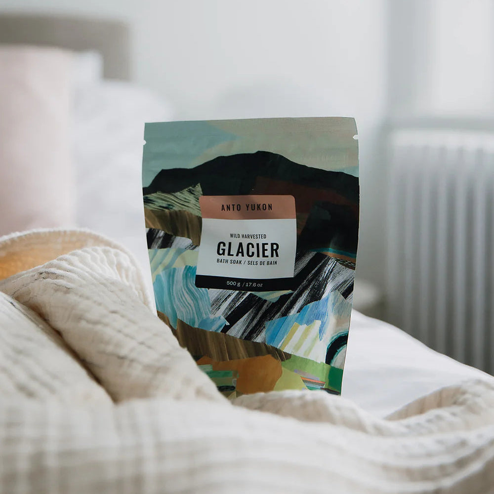 Packaged product labeled 'Glacier' on a bed with a blurred background