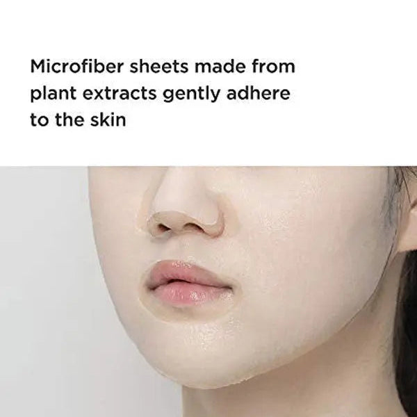 Close-up of a person's face with text about microfiber sheets made from plant extracts.