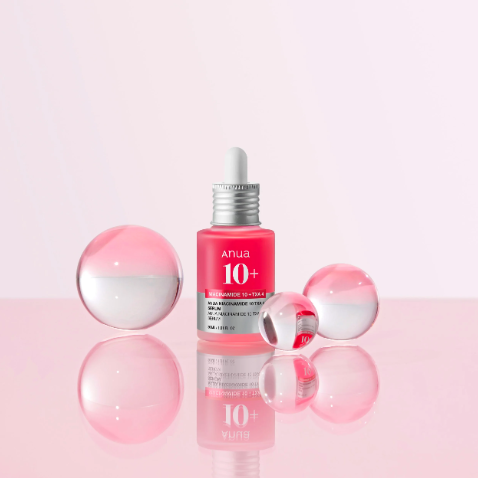 Anua 10+ serum bottle with dropper on a white background