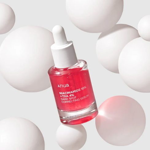 Pink serum bottle with dropper on a white background