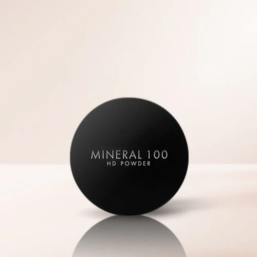 Black container of Mineral 100 HD Powder on a light beige background