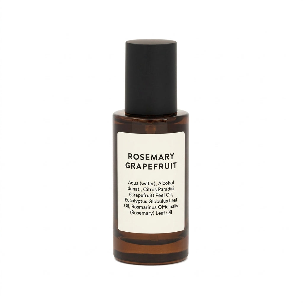 Rosemary Grapefruit peeling oil in an amber glass bottle with a black cap and a white label, shown on a plain white background.