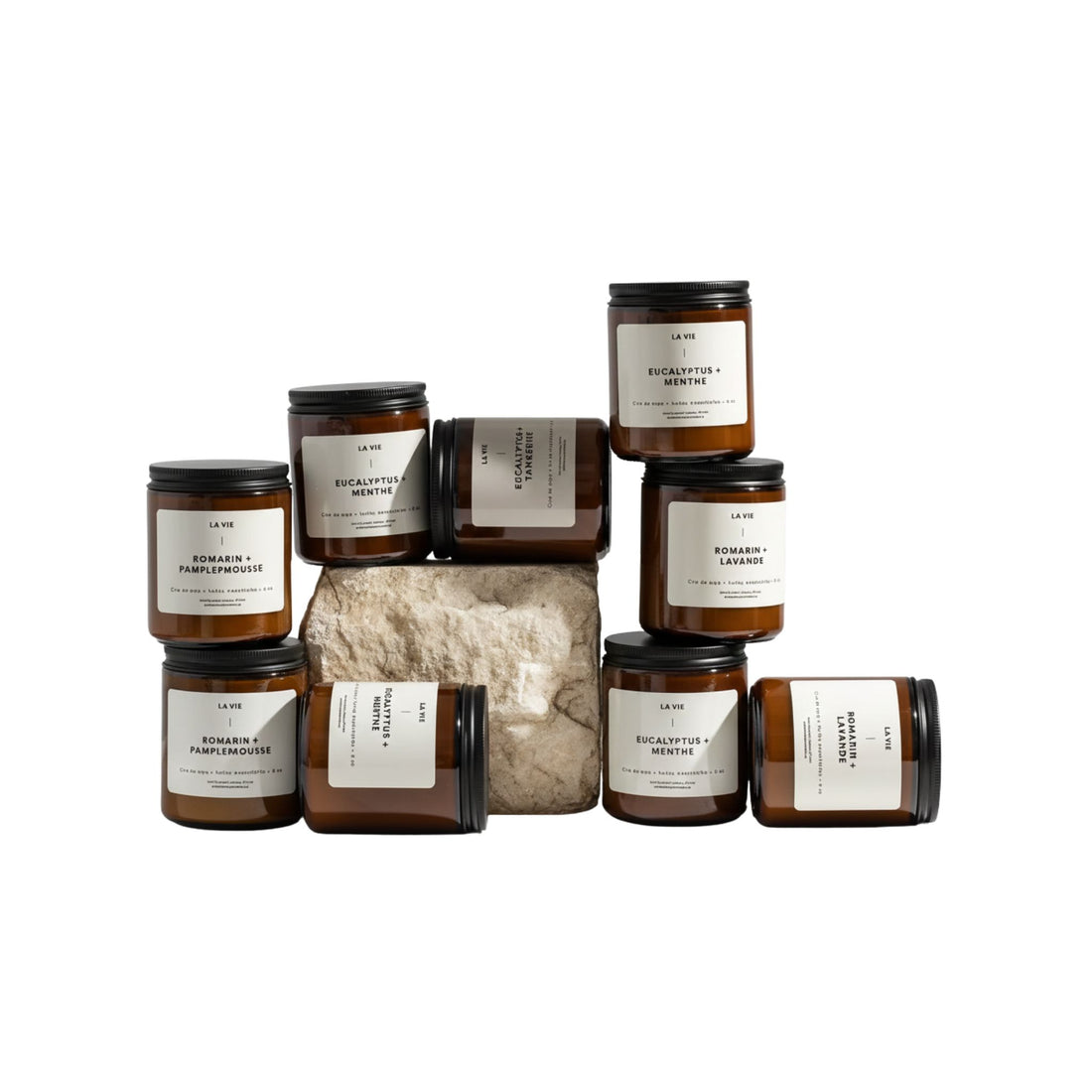 Collection of candles and a bag with labels on a white background