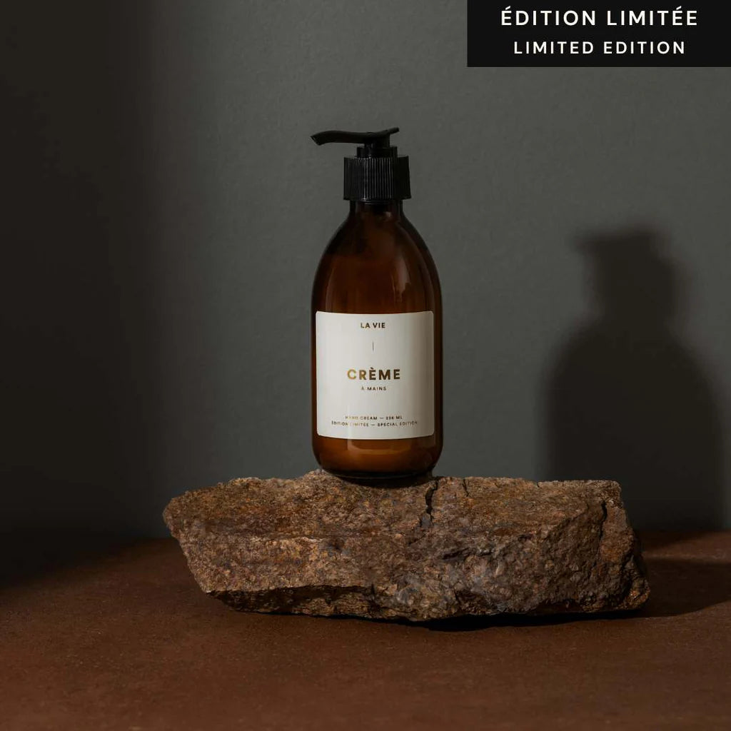 Brown bottle of crème on a stone surface with a dark background