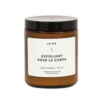 Brown jar of body scrub with a white label on a white background