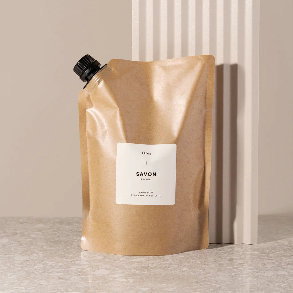 Brown soap packaging with a white label on a neutral background