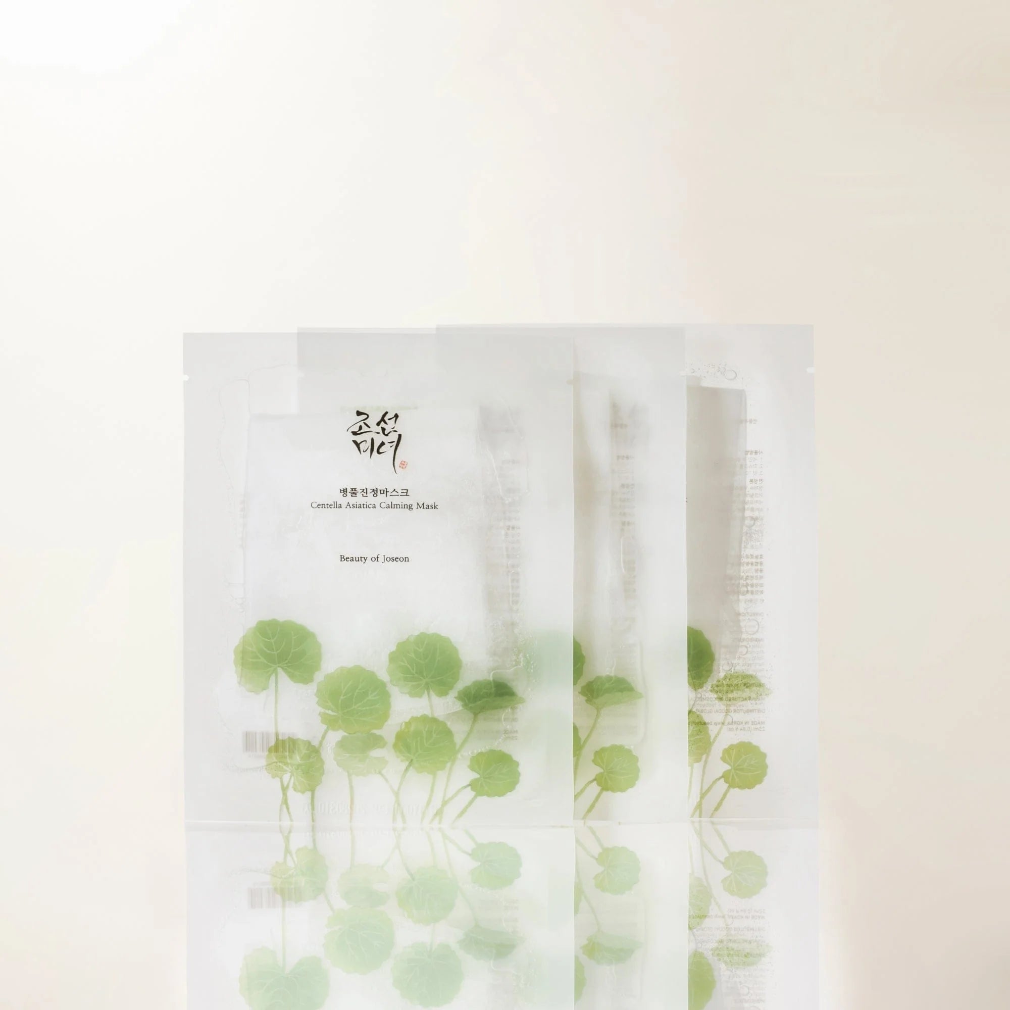 Sheet mask packaging with green leaf design on a white background