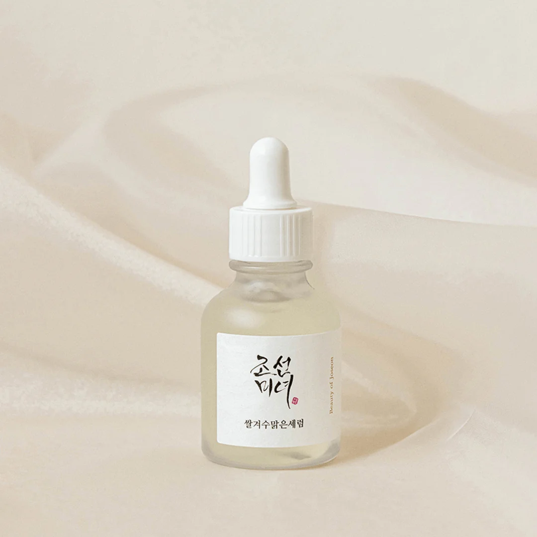 Skincare dropper bottle with a white label on a beige background