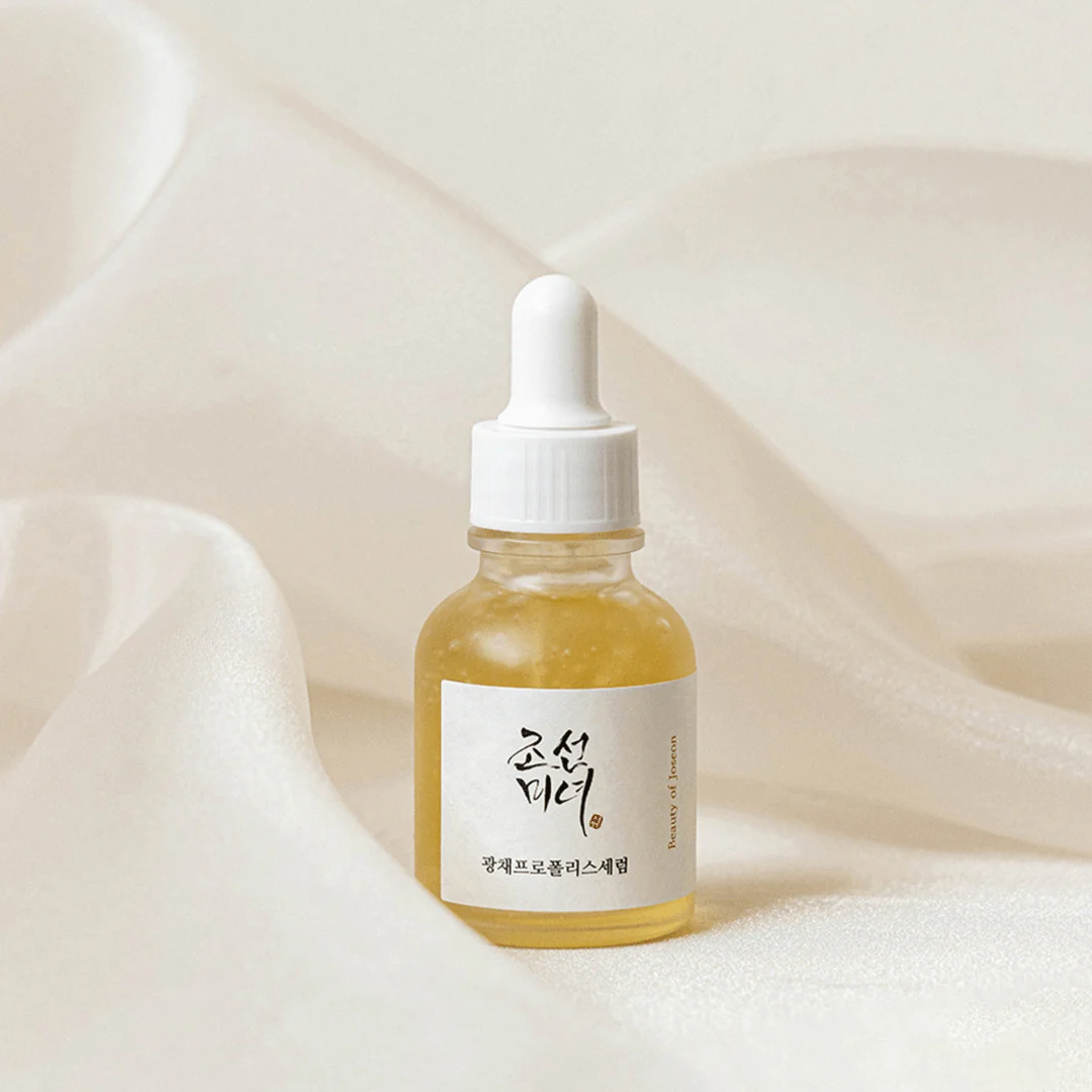 Skincare serum bottle with dropper on a white background
