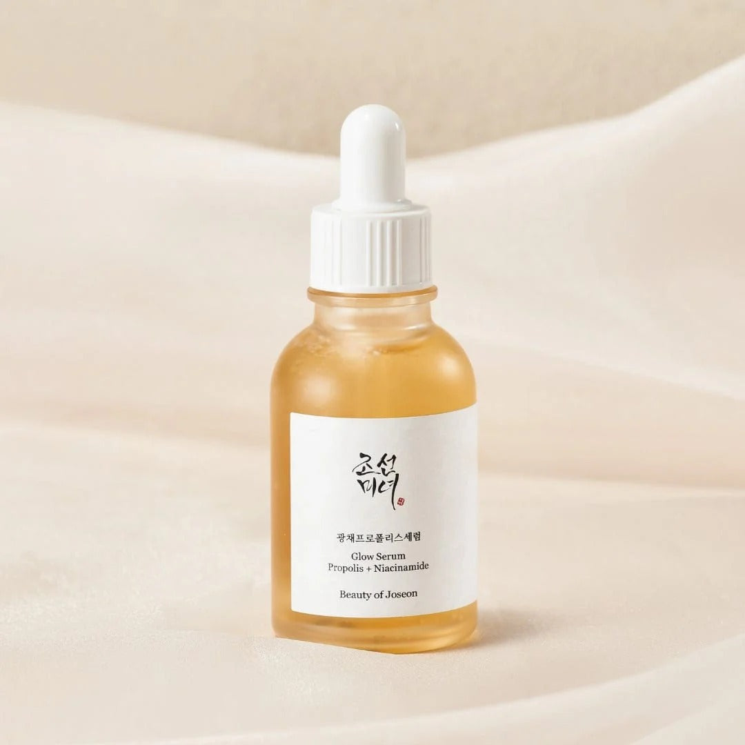 Skincare serum bottle with dropper on a beige background