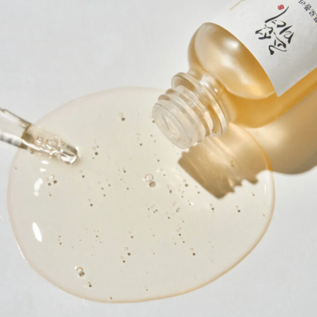 Bottle of skincare serum with dropper and liquid on a white background