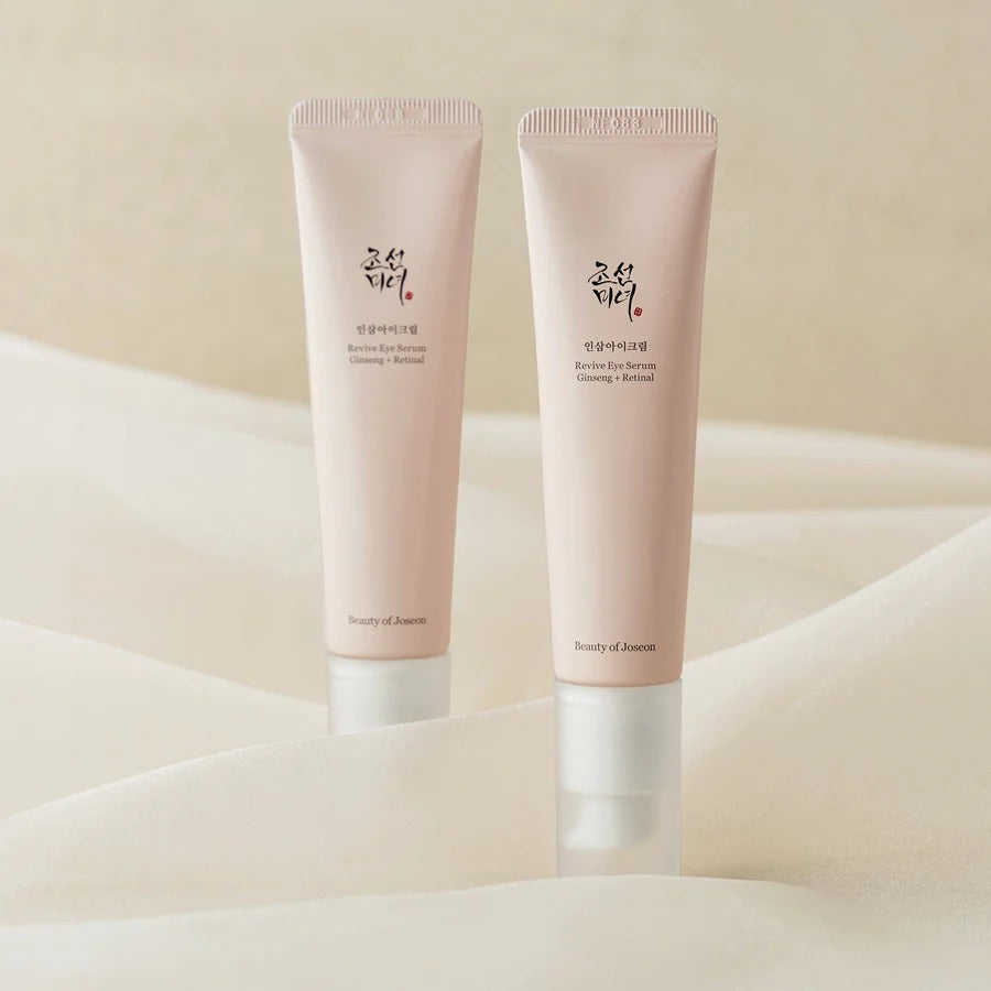 Two pink skincare tubes on a beige background