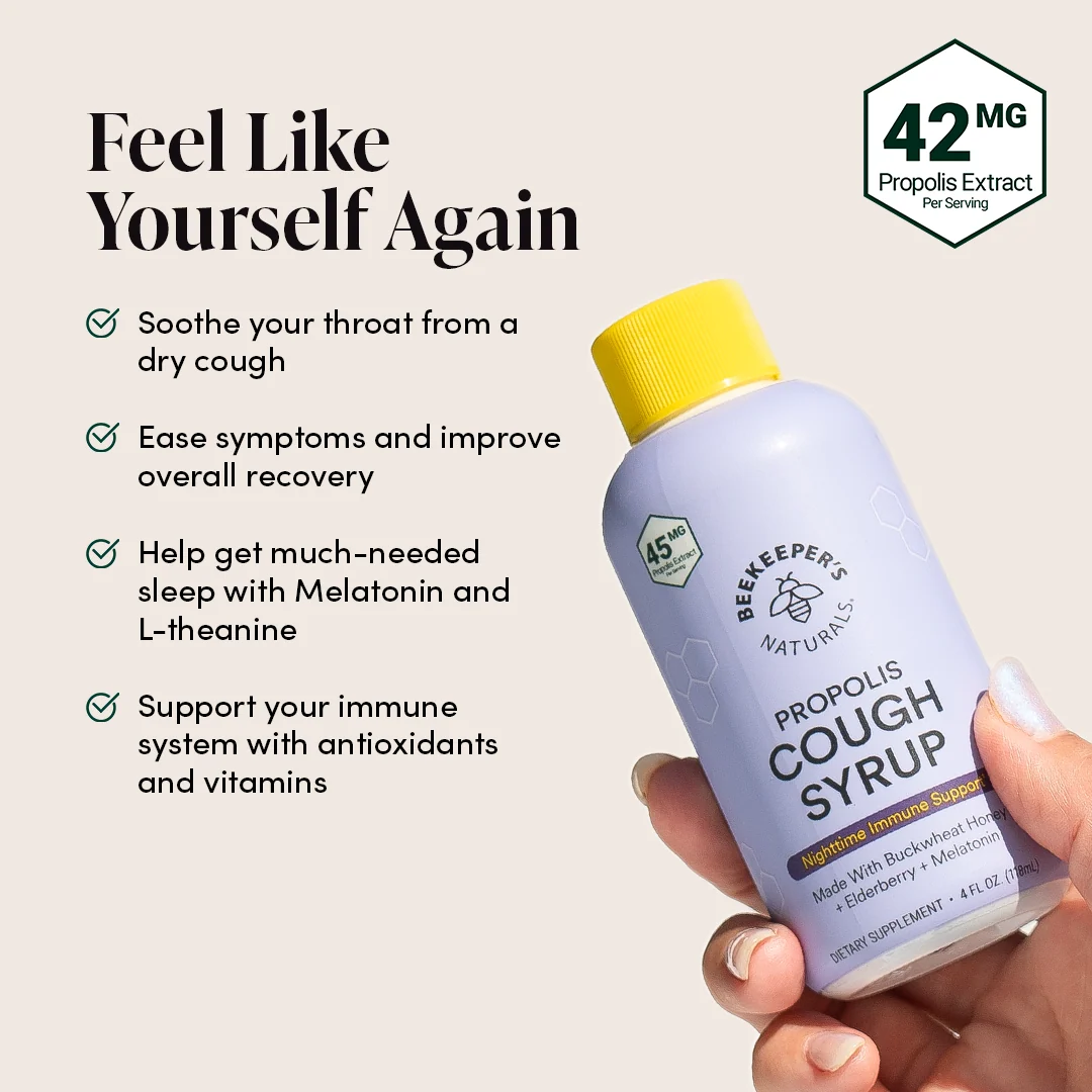 Beekeeper's Naturals Propolis Cough Syrup bottle held by a hand with product details on a light background.