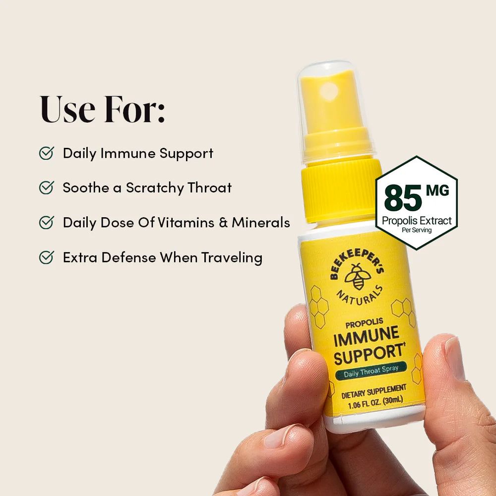 Yellow spray bottle labeled 'Beekeeper's Naturals' held by a hand with product features listed.