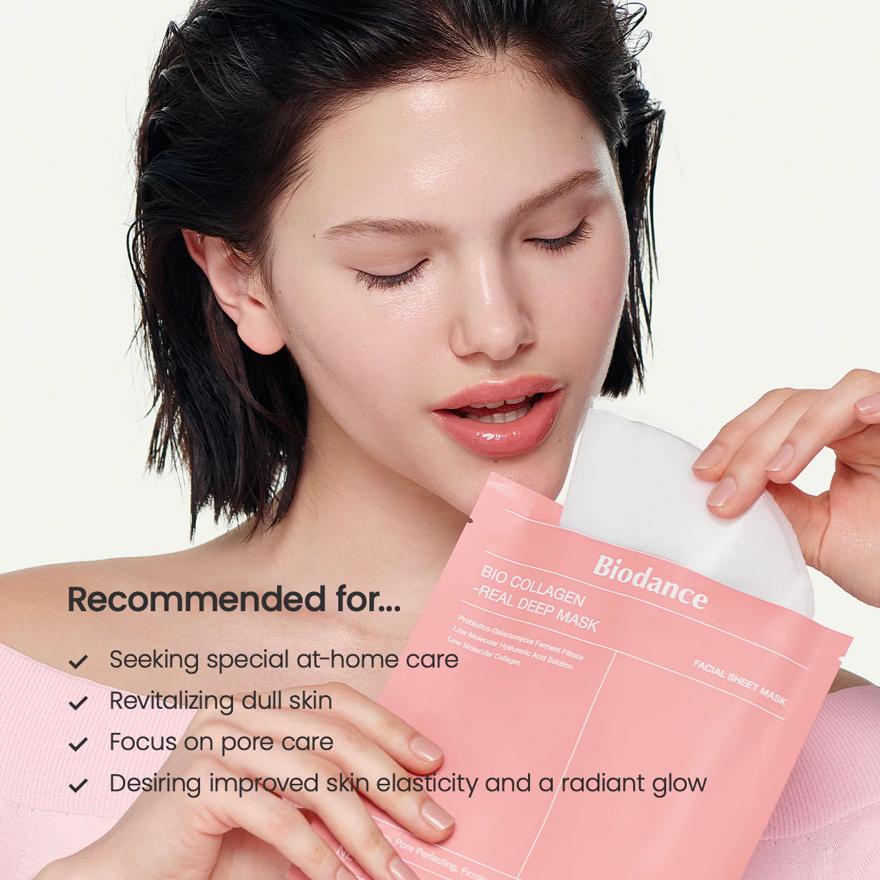 Woman holding a Biodance facial sheet mask with product details on a light pink background