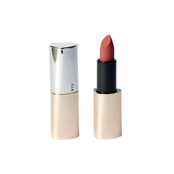 A lipstick shown open next to its closed case on a plain white background. The lipstick bullet is a muted dusty rose pink, and the packaging features a metallic silver top and a champagne-gold base.