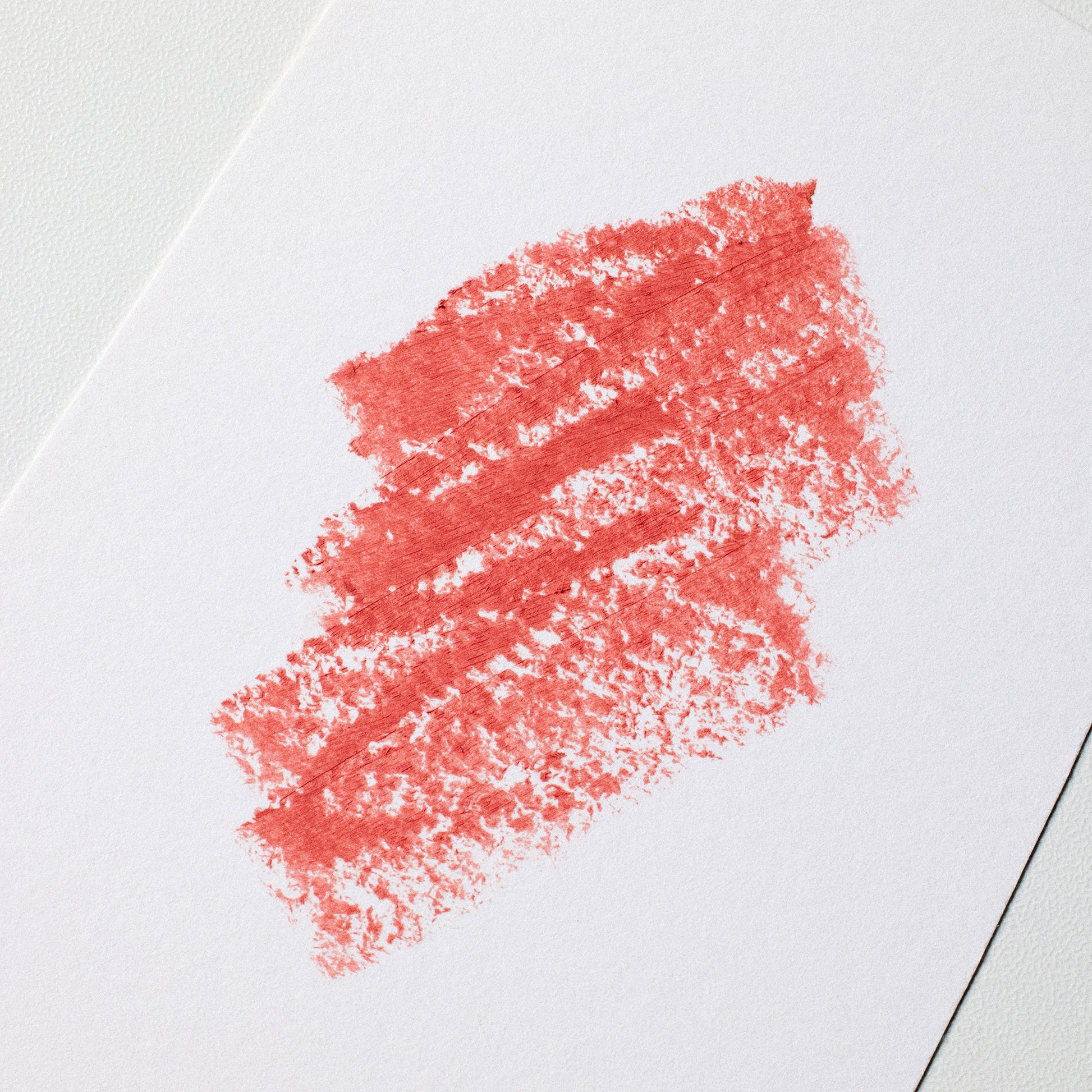 Red lipstick smear on a white background