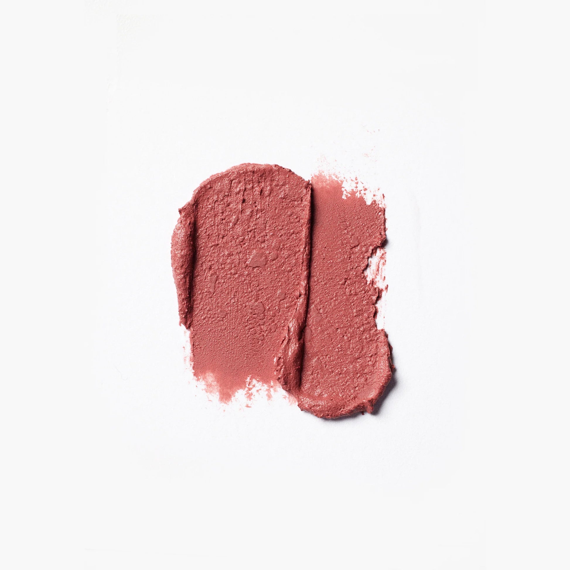 Two swatches of pink makeup on a white background