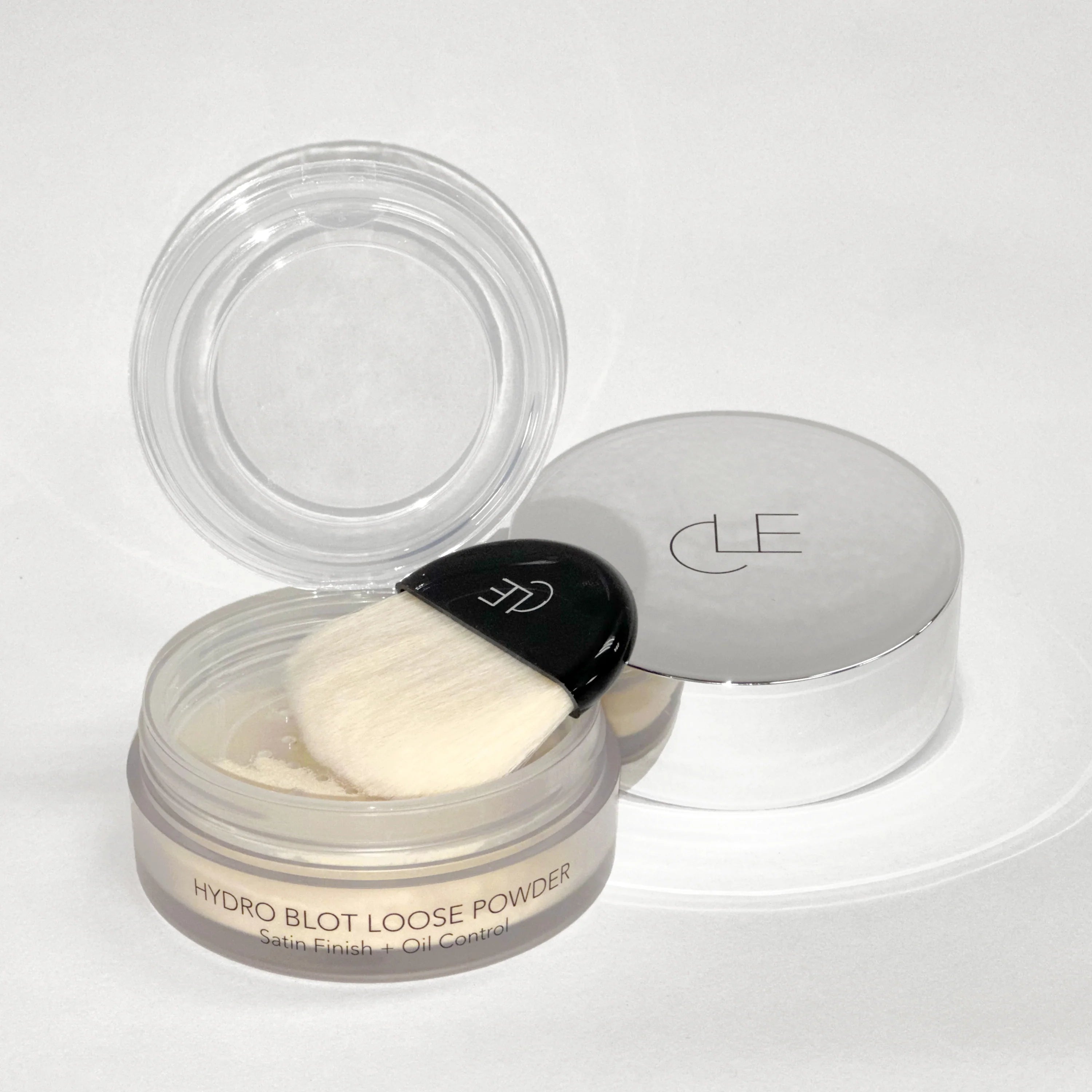 Hydro blot loose powder with a black scoop on a white background
