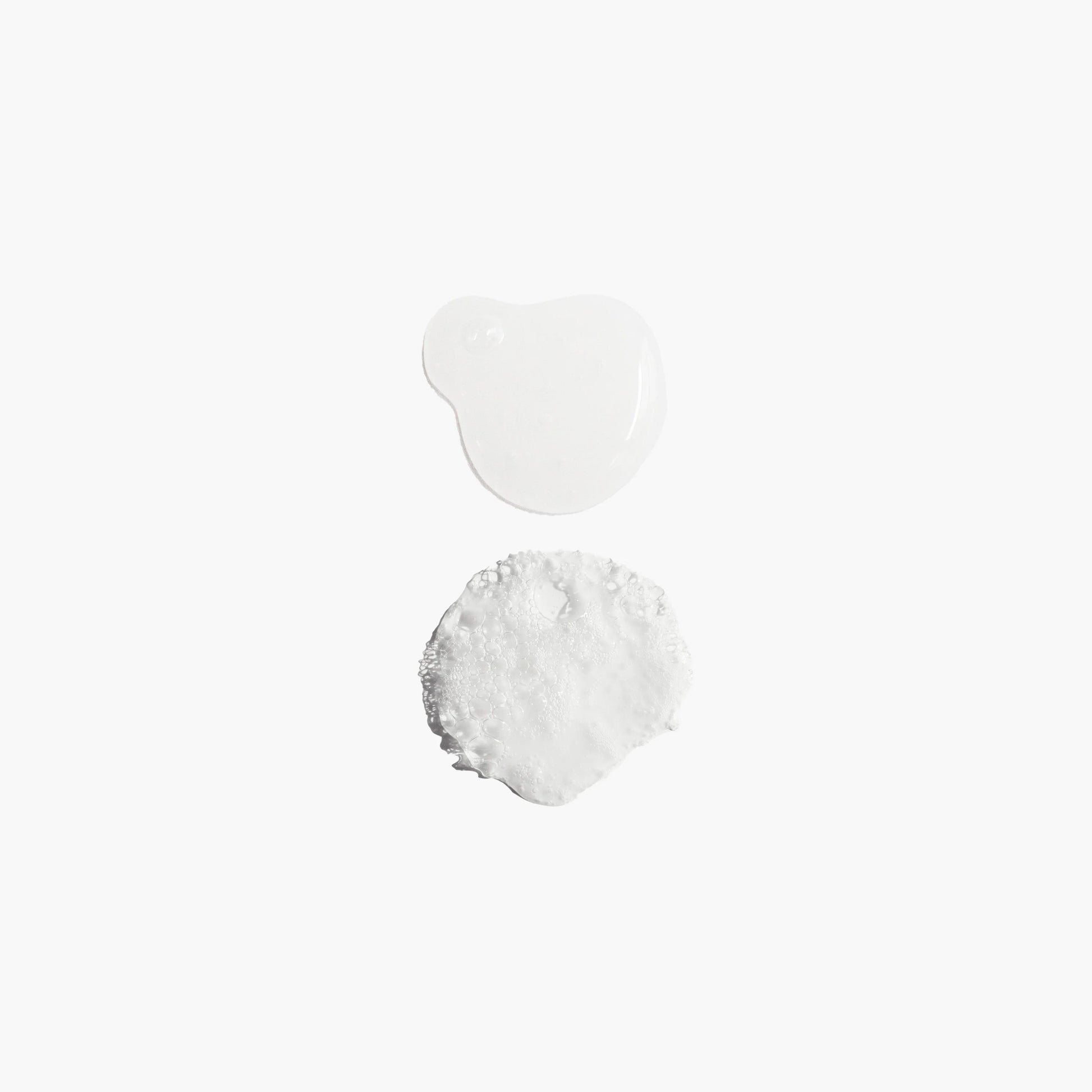 Two white powder samples on a light gray background