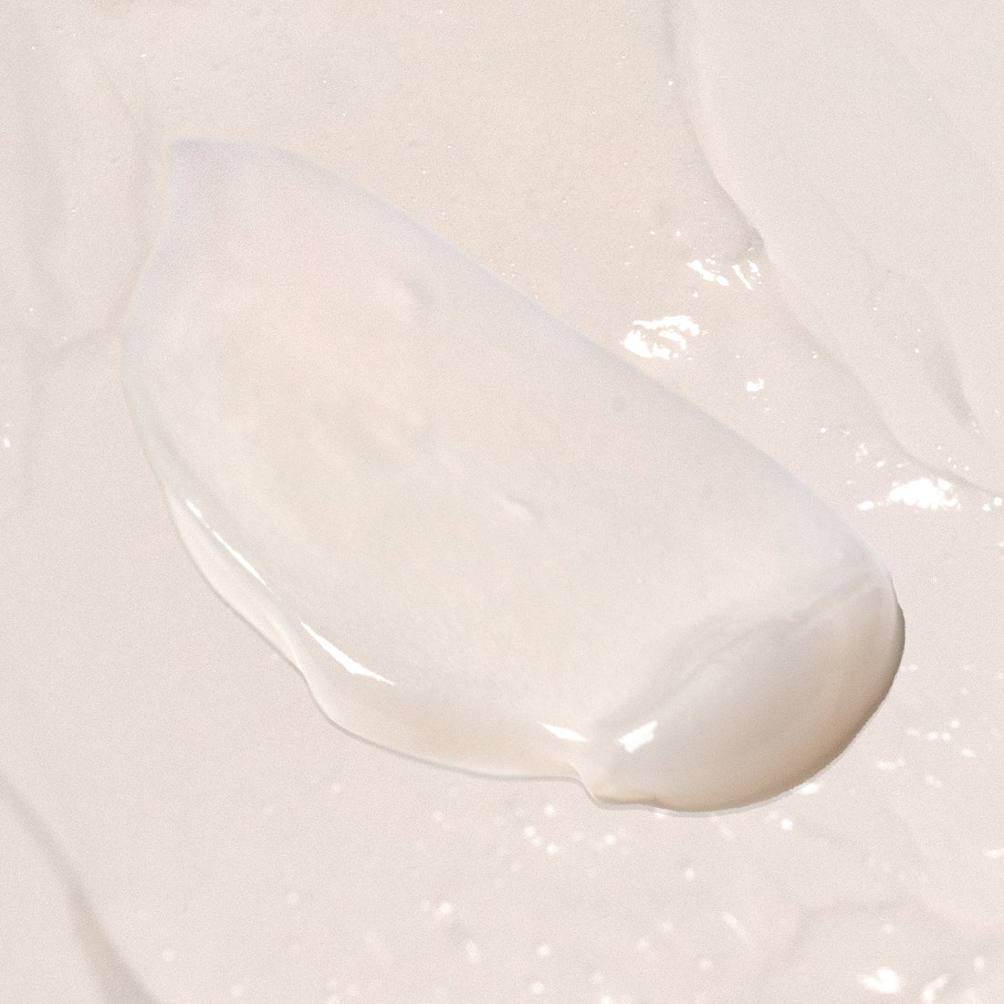 Skincare serum bottle with white cap and visible brand logo on a white background
