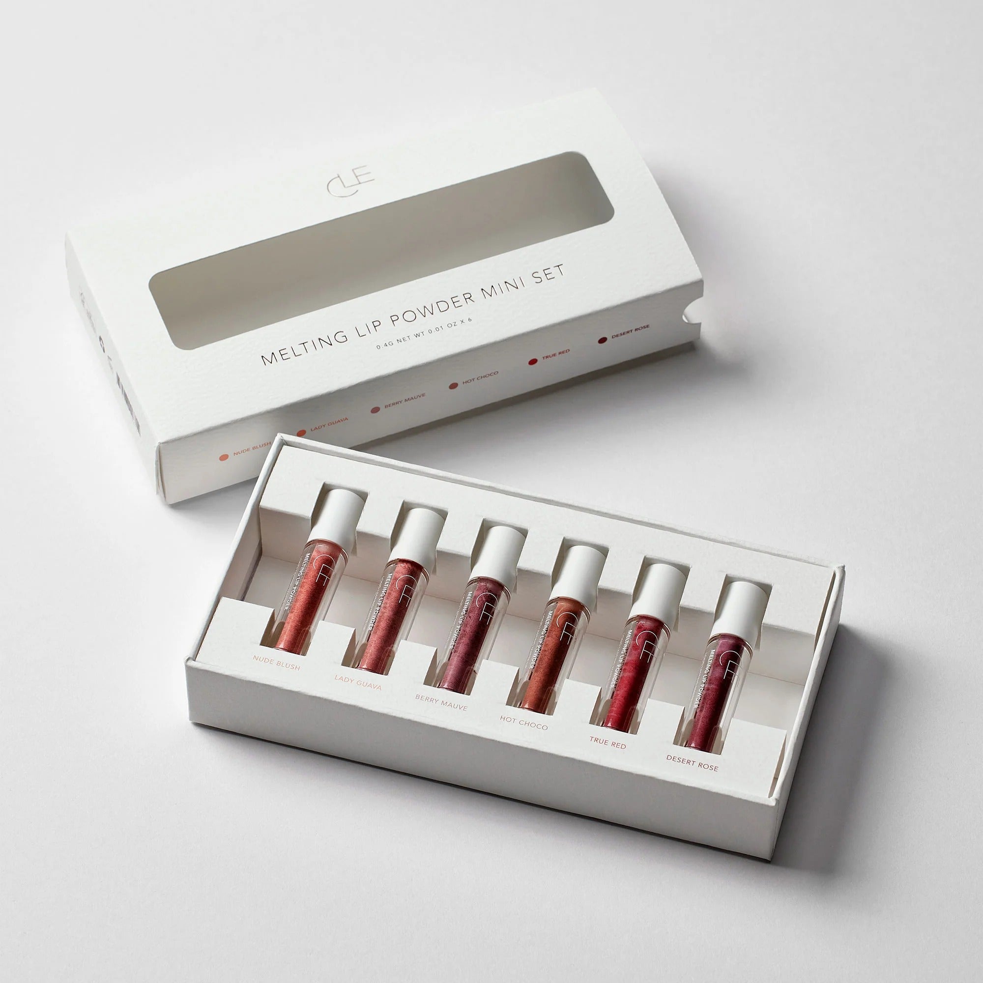 Set of lip powder miniatures in a white box on a light gray background