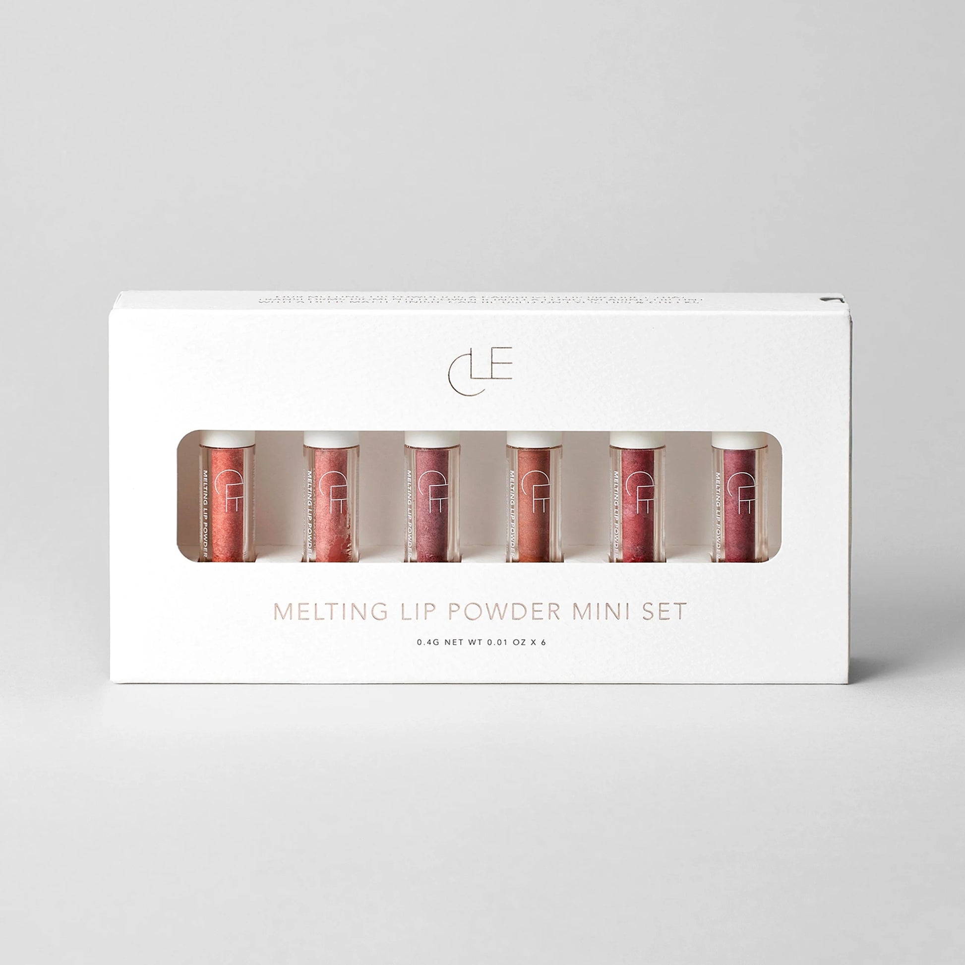 Set of lip powder miniatures in a branded box on a light gray background