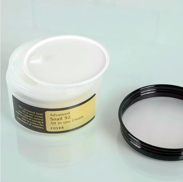 Cosmetic cream jar with a black lid on a light gray background