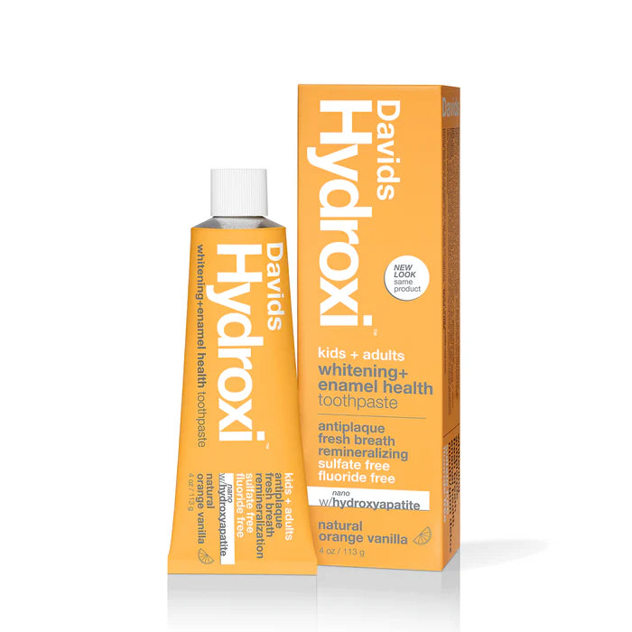 A tube of Davids Hydroxi tooth powder in orange with a white cap, shown on a plain white background.