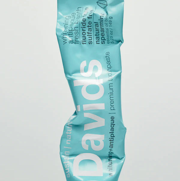 Tube of Davids toothpaste on a light gray background