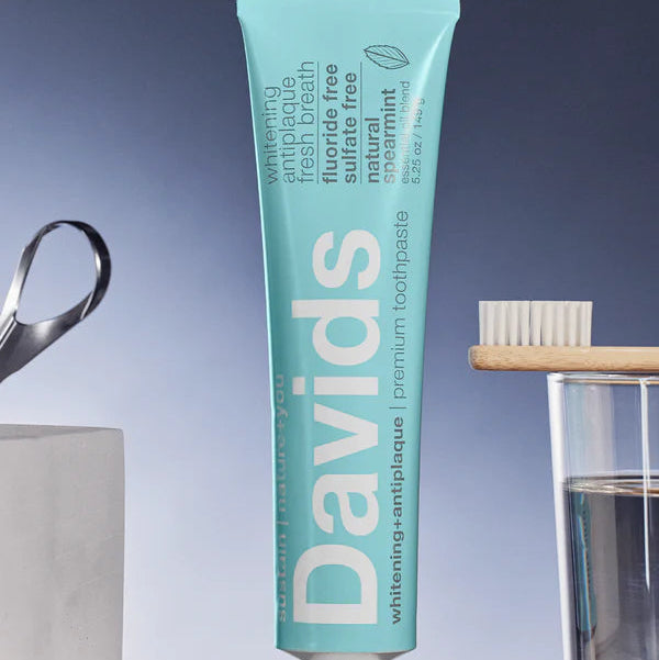Davids toothpaste tube on a gray surface with a blue gradient background