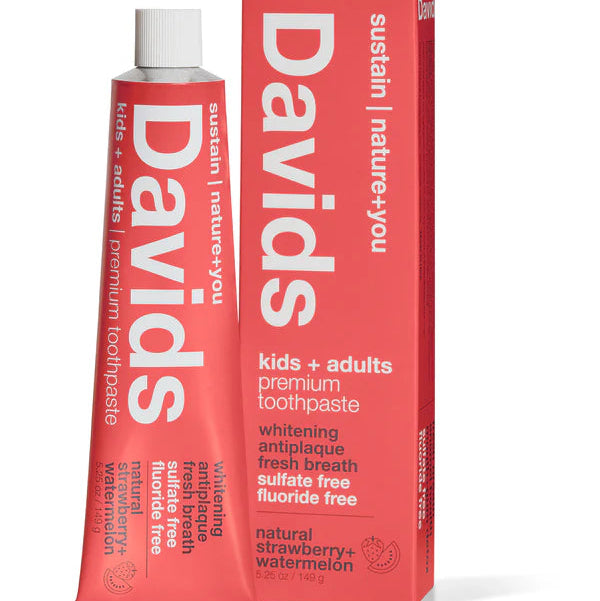 A tube of Davids Whitening Toothpaste for kids, featuring a bright red body with white text and a white cap, shown on a plain white background.