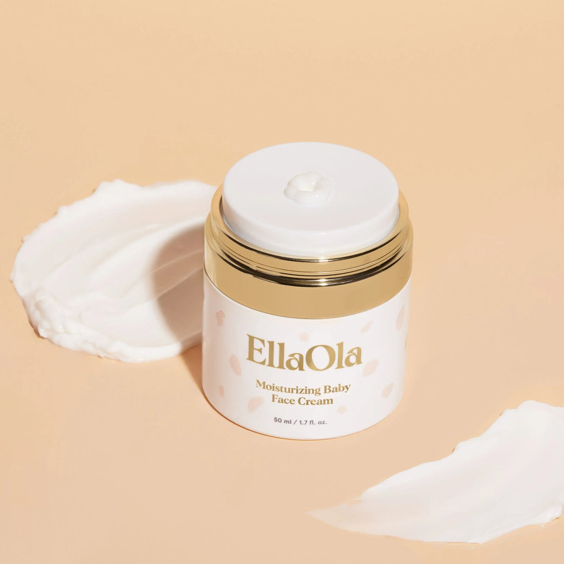 EllaOla Moisturizing Baby Face Cream in a white and gold jar for gentle infant skincare.