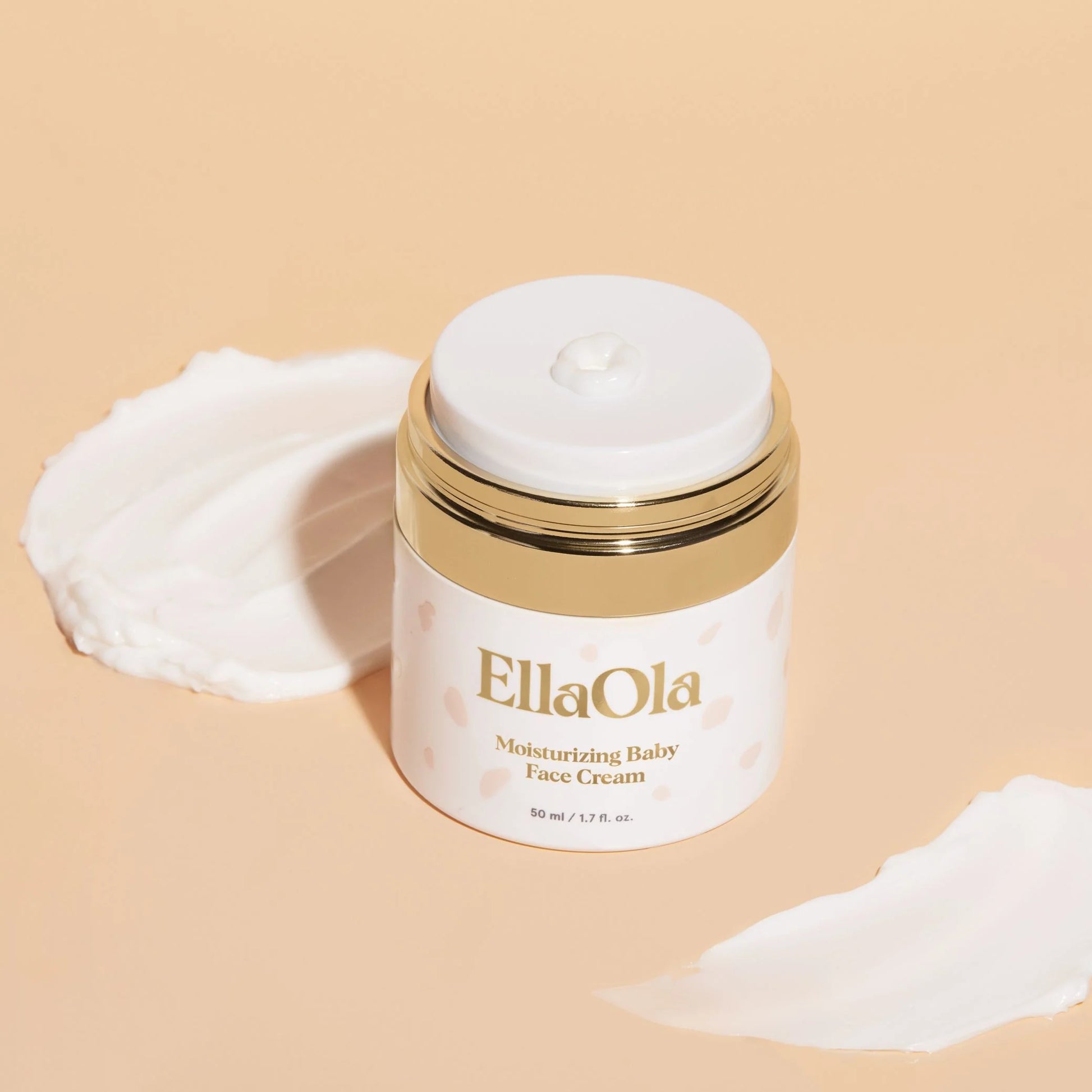 EllaOla moisturizing baby face cream jar with cream on a beige background