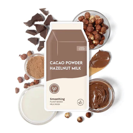 Cacao powder, hazelnut milk, and chocolate pieces on a white background