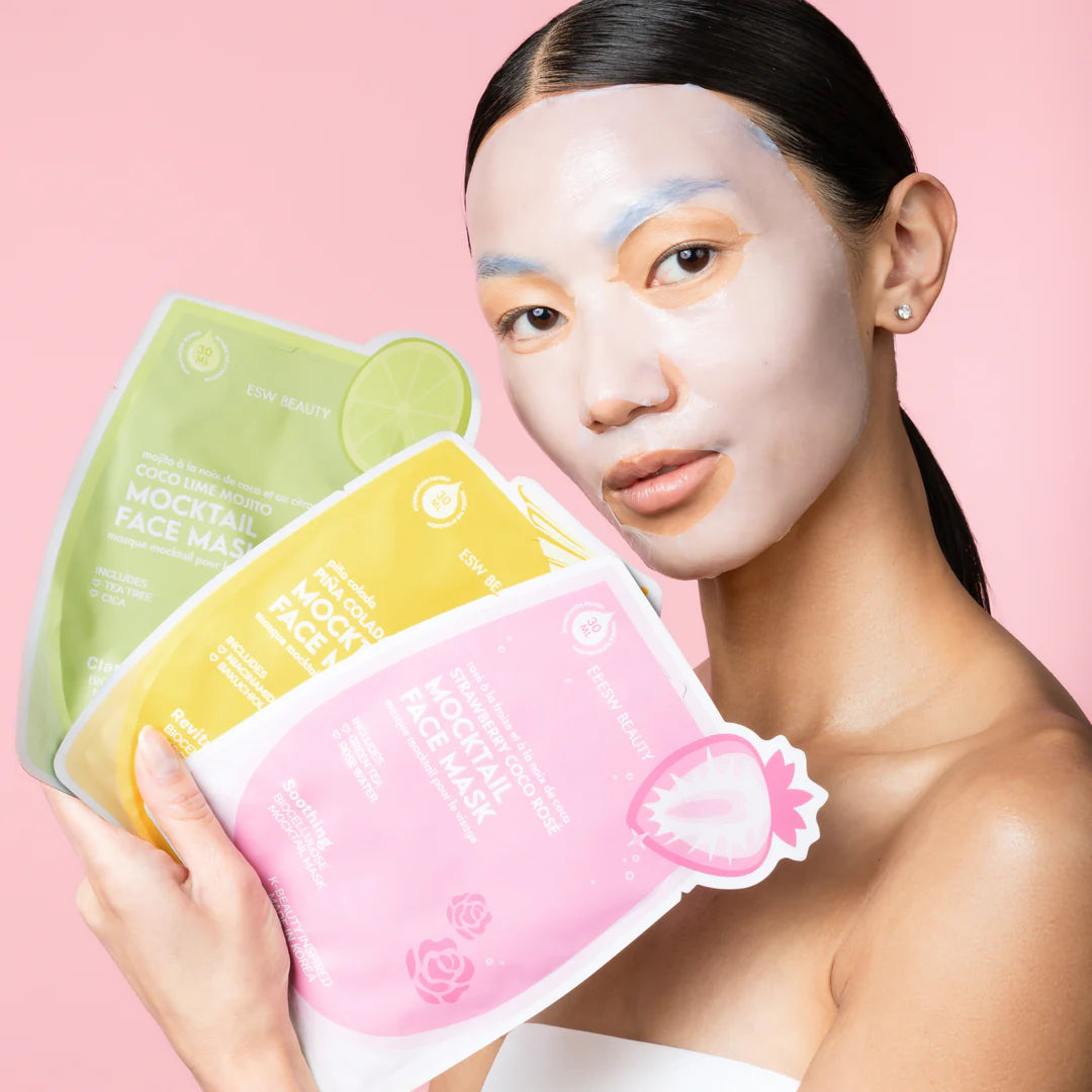 Model wearing a biocellulose sheet mask from The Pharmacy Lab ESW Beauty Mocktail Face Mask Set for hydrating and soothing skincare