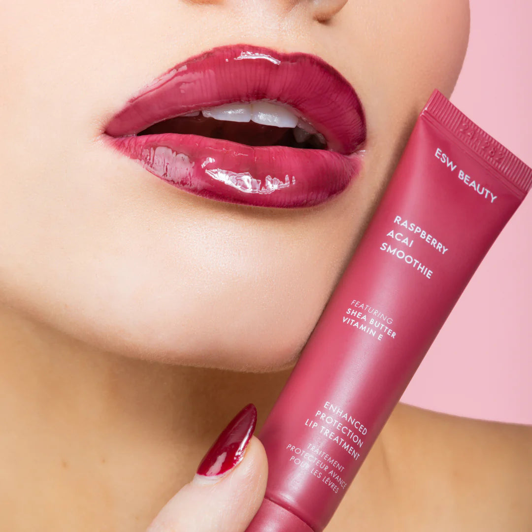 Close-up of glossy lips wearing The Pharmacy Lab ESW Beauty Raspberry Acai Smoothie Enhanced Protection Lip Treatment for hydration and shine