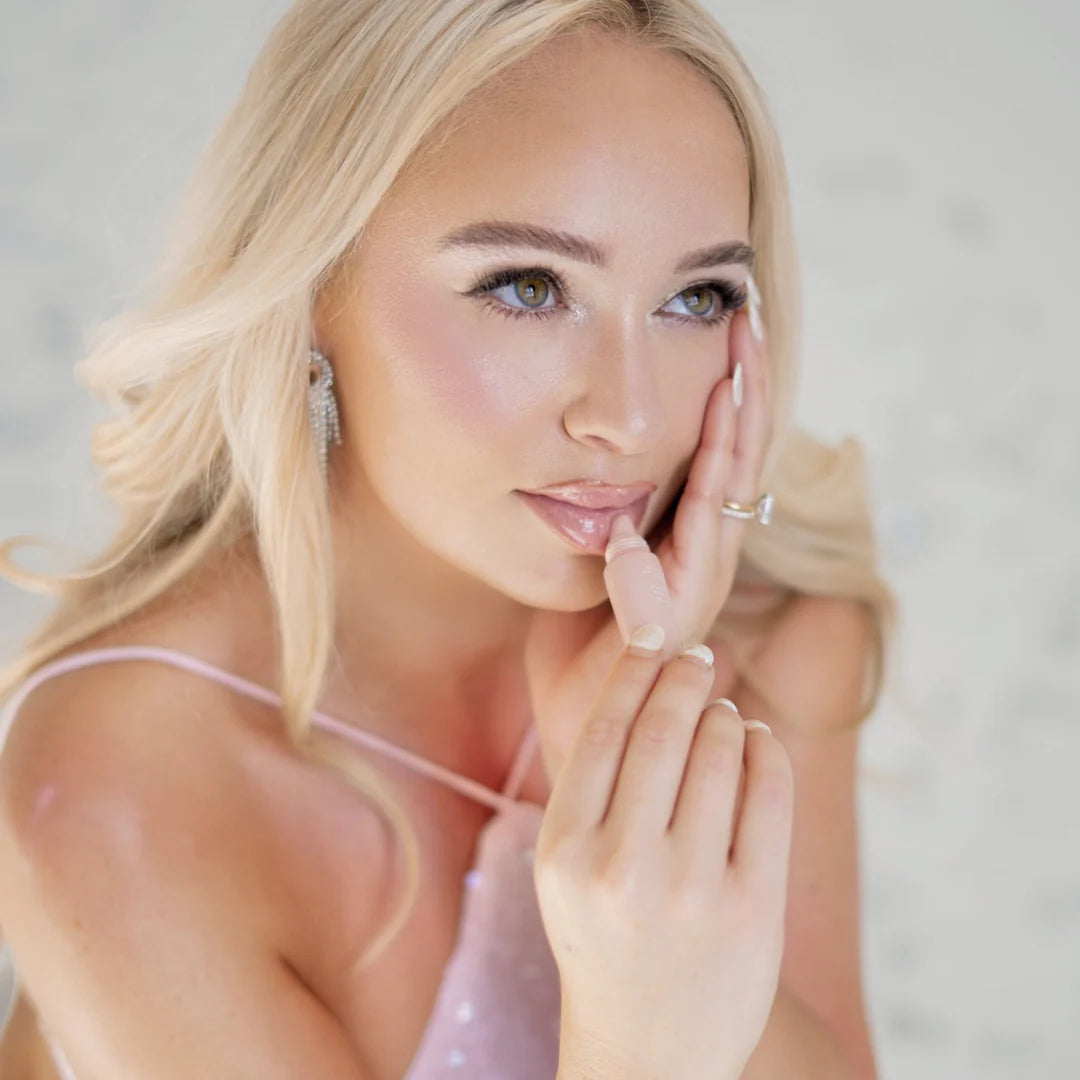 Model applying ESW Beauty Rose Sugar Smoothie Lip Treatment for hydrated, glossy lips, featured by The Pharmacy Lab.