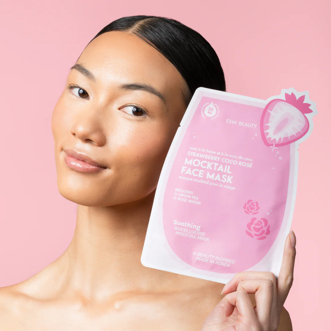 Model holding ESW Beauty Strawberry Coco Rosé Soothing Biocellulose Mocktail Mask, a calming and hydrating face mask available at The Pharmacy Lab.