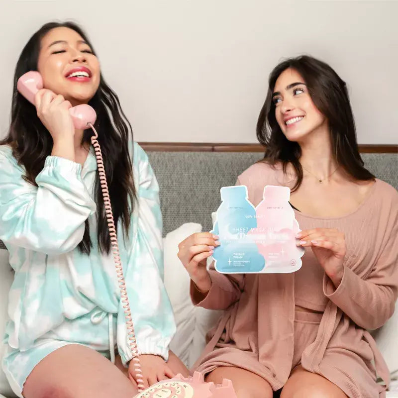 Friends enjoying a self-care moment with ESW Beauty The Dream Team Sheet Mask Duo from The Pharmacy Lab in a cozy at-home setting.