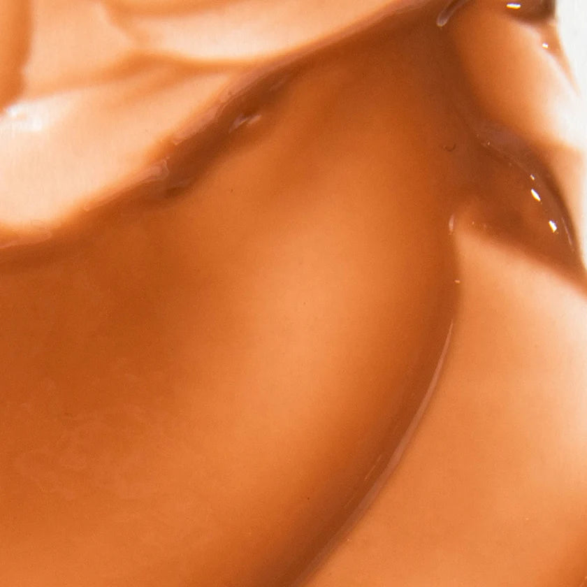 Close up texture of ESW Beauty Vanilla Almond Butter Smoothie Lip Treatment showing glossy light caramel finish at The Pharmacy Lab
