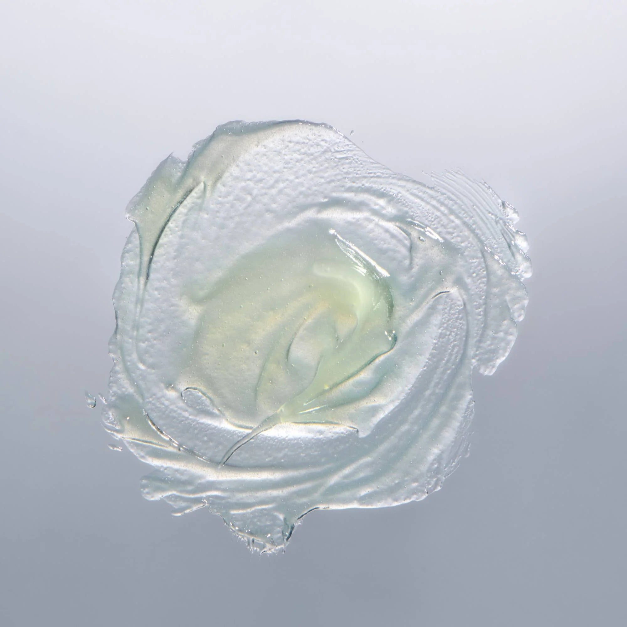 Clear gel-like substance on a gray background