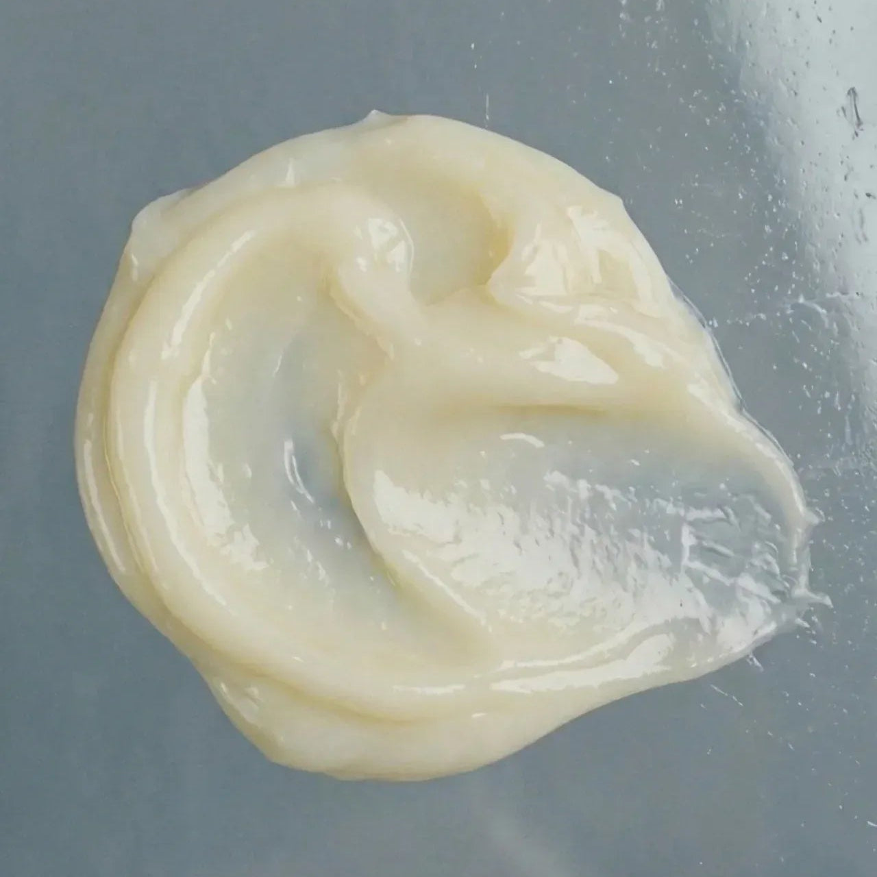 White, gel-like substance on a gray background