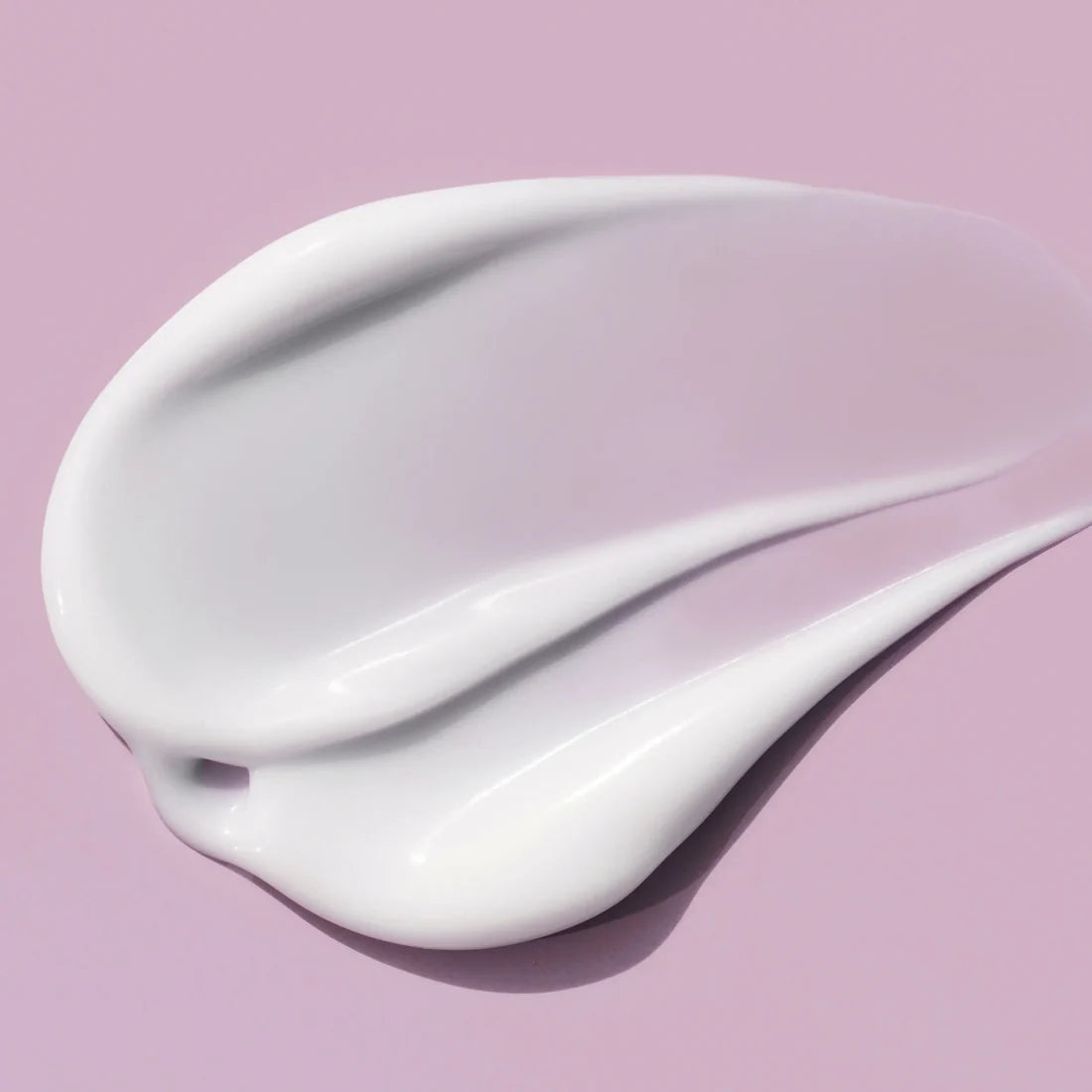 White cream swatch on a pink background