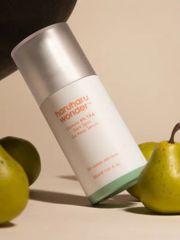 Skincare bottle labeled 'haruharu wonder' with pears on a beige background