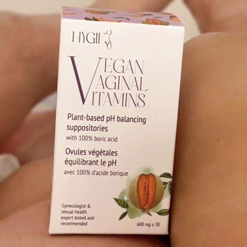Box of Vegan Vaginal Vitamins on a person's leg with blurred background